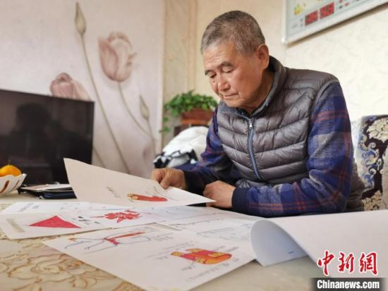 圖為陸鵬飛向記者展示多年帶隊(duì)的手寫筆記?！堟?攝